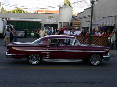 [A maroon two-door with lots of chrome on the sides and along the edges.]